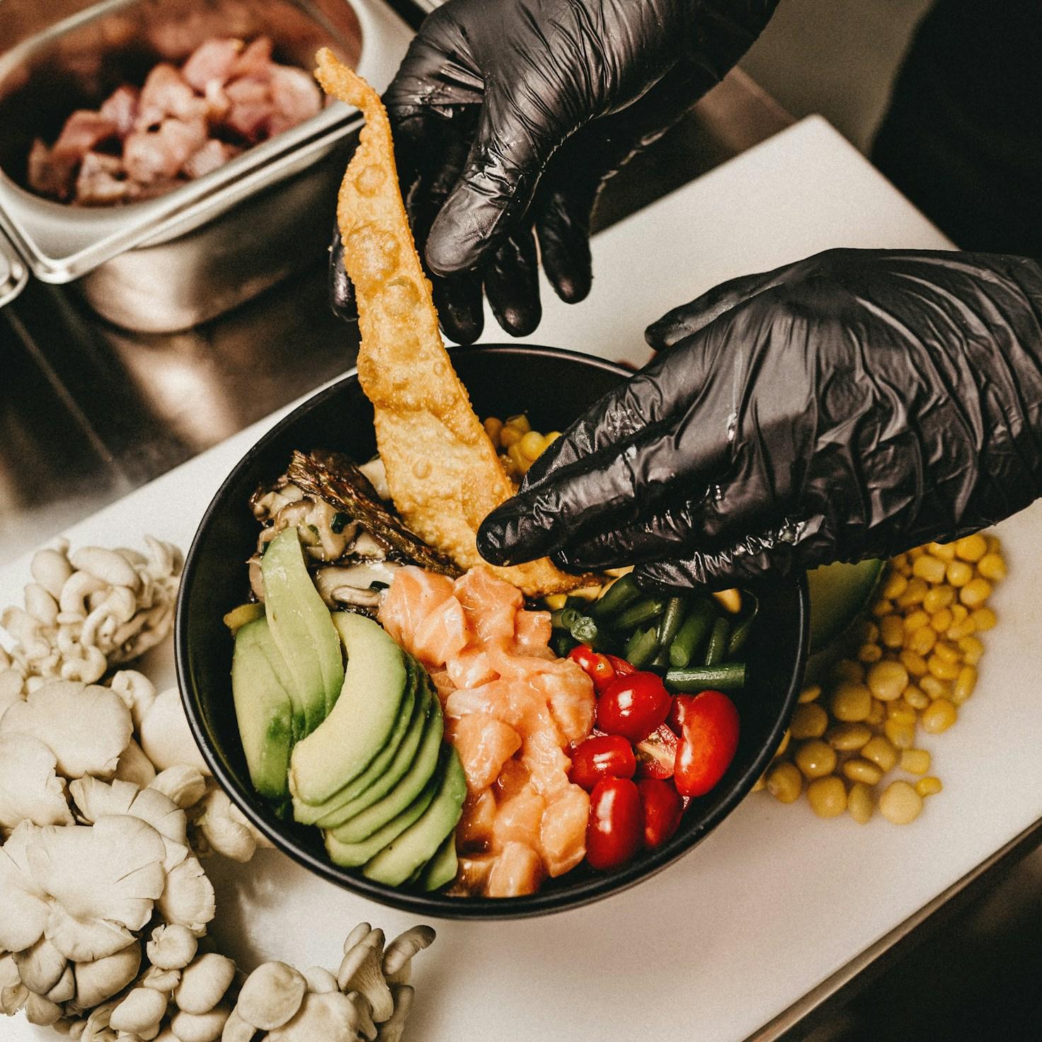 Diverse group of community members sharing a meal together, showcasing the social bonds formed through collaborative cooking